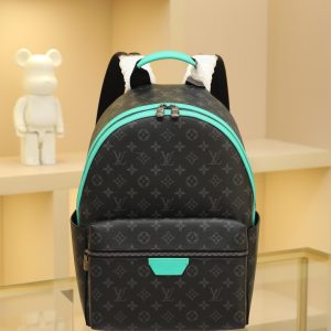 • Monogram Eclipse coated canvas • Full-grain leather trim • Fabric lining • Metal hardware • Double zipper closure • Adjustable shoulder strap • Open side pockets • Zippered front pocket • Interior patch pocket • Handle: Single handle